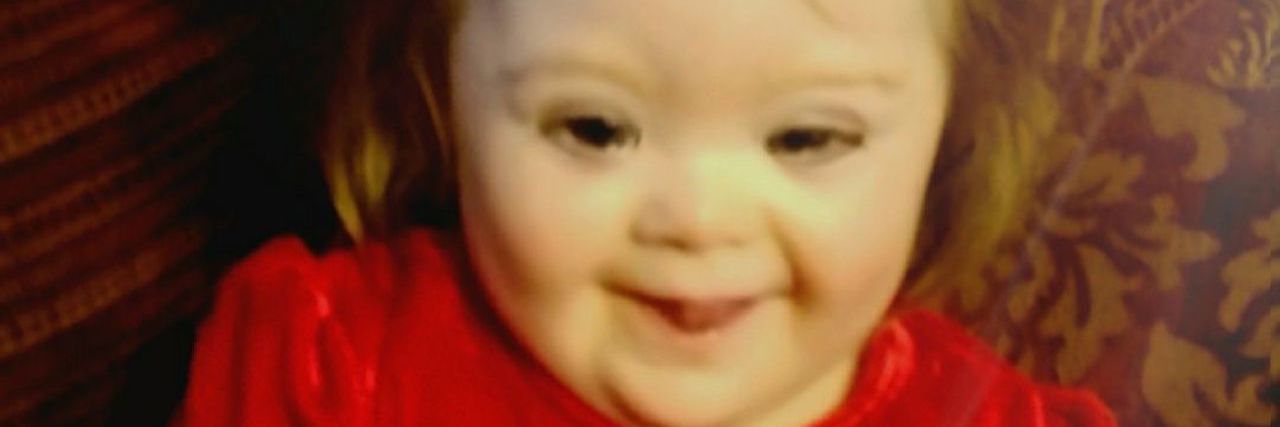 Woman Wouldn't Make Eye Contact With My Daughter With Down Syndrome Little girl with Down syndrome wearing red dress. Over the photo the words: "I believe I will make a difference in this world"