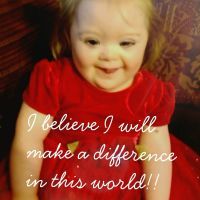 Little girl with Down syndrome wearing red dress. Over the photo the words: "I believe I will make a difference in this world"