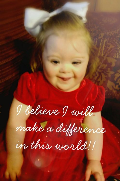 Little girl with Down syndrome wearing red dress. Over the photo the words: "I believe I will make a difference in this world"