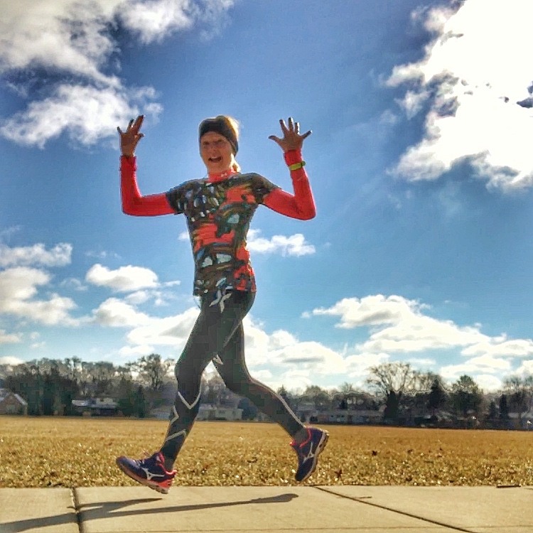 A photo of the writer walking with her hands in the air.