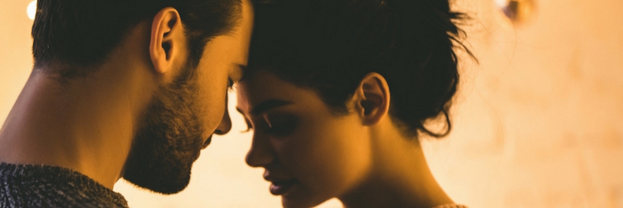 25 People Share How Mental Illness Affects Their Sex Life A couple with their foreheads touching. Text reads: 25 people share how mental illness affects their sex lives