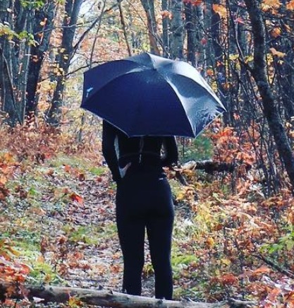 the author with her UV umbrella in the woods