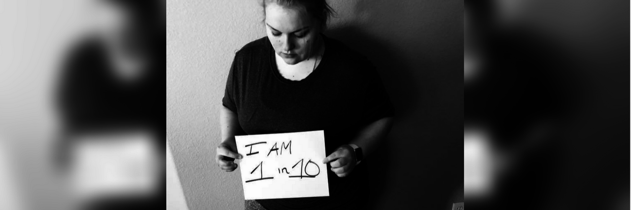Sharing My Story During Endometriosis Awareness Month black and white photo of a woman holding a sheet of paper that says 'I am 1 in 10'