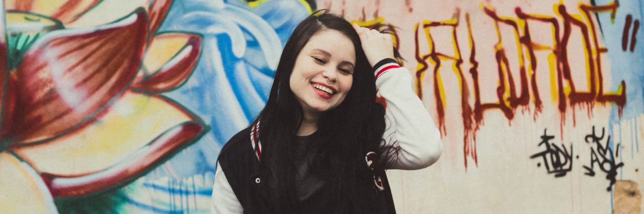 I Am More Than Just My ADHD smiling teen in front of a colorful wall