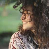 woman with curly hair smiling