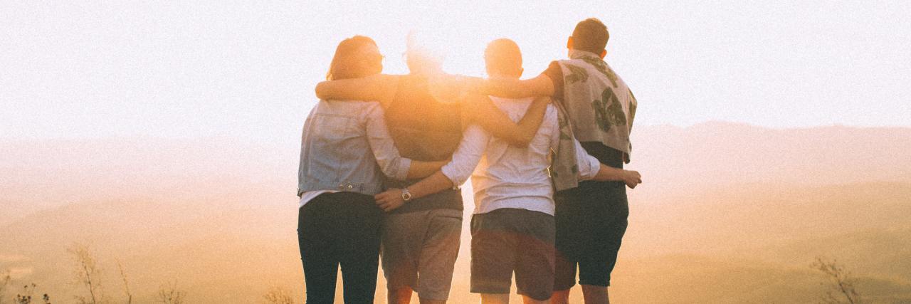 How to Support a Friend Who Is Chronically Ill four friends standing on a mountain overlooking a foggy valley