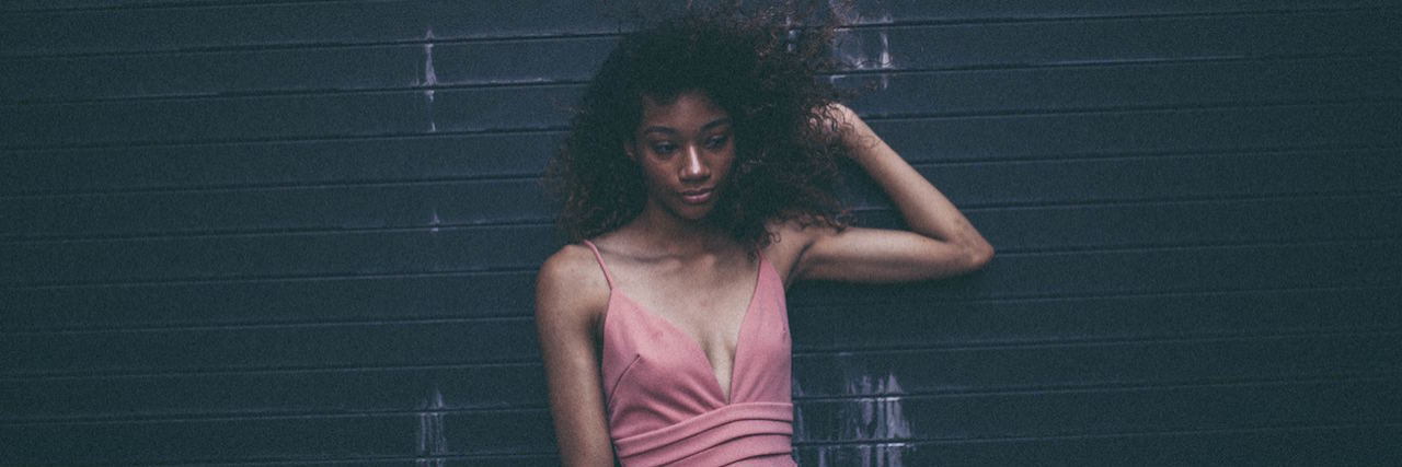 What It's Like Being a Somali Woman With a Mental Illness A Somali woman posing in front of a wall