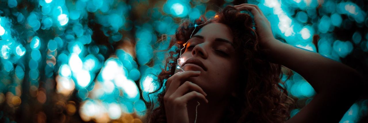 10 Coping Strategies That Empower Me as a Sexual Assault Survivor woman in forest with light on her face