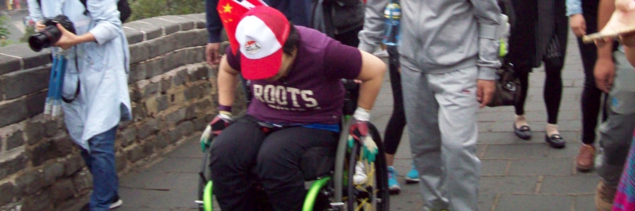Rolling on the Great Wall of China in a Wheelchair Kuen rolling along the Great Wall of China.