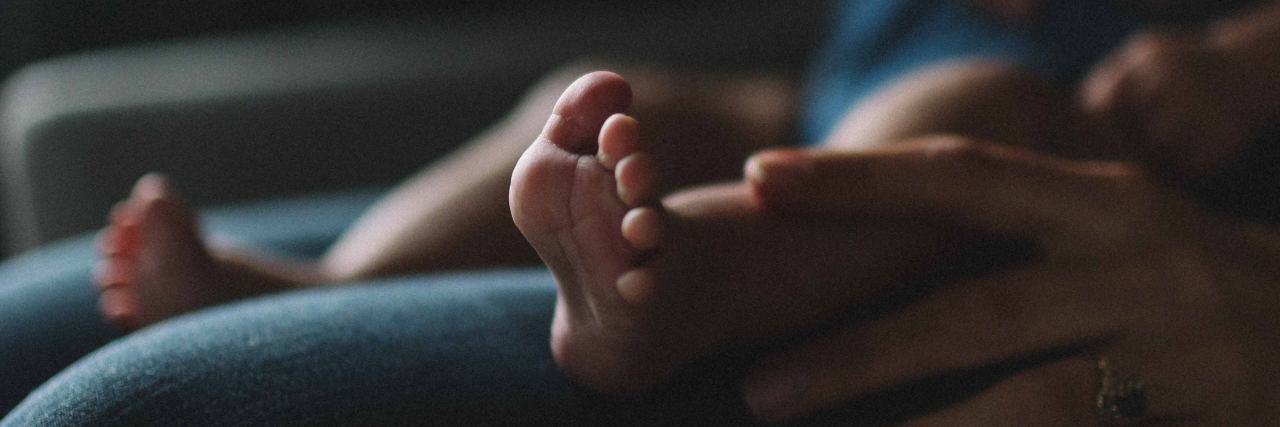 Showing What It's Really Like to be the Mom to a Boy With Autism mom with baby on her lap