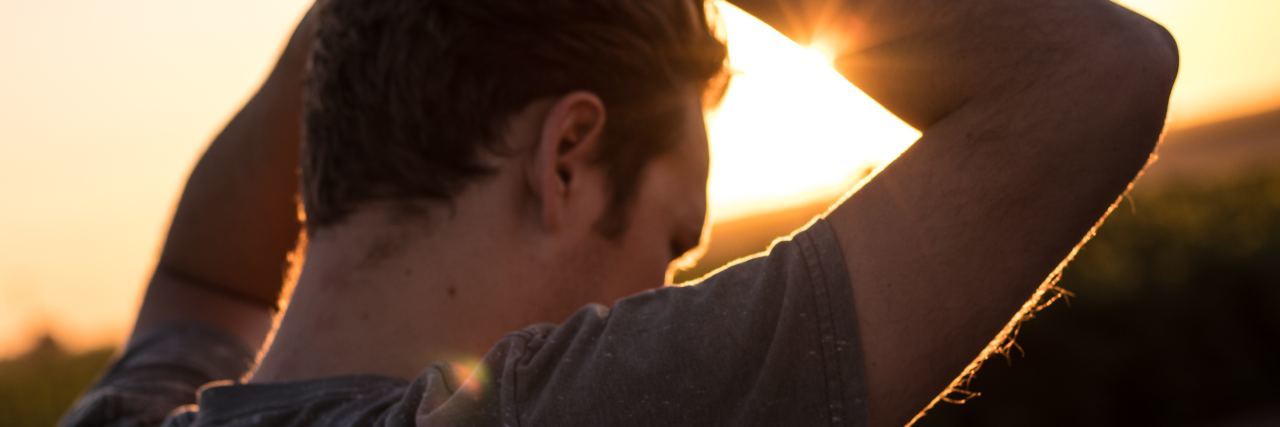 What I Want You to Understand as a Man With Suicidal Thoughts man silhouetted at sunset looking upset and desperate