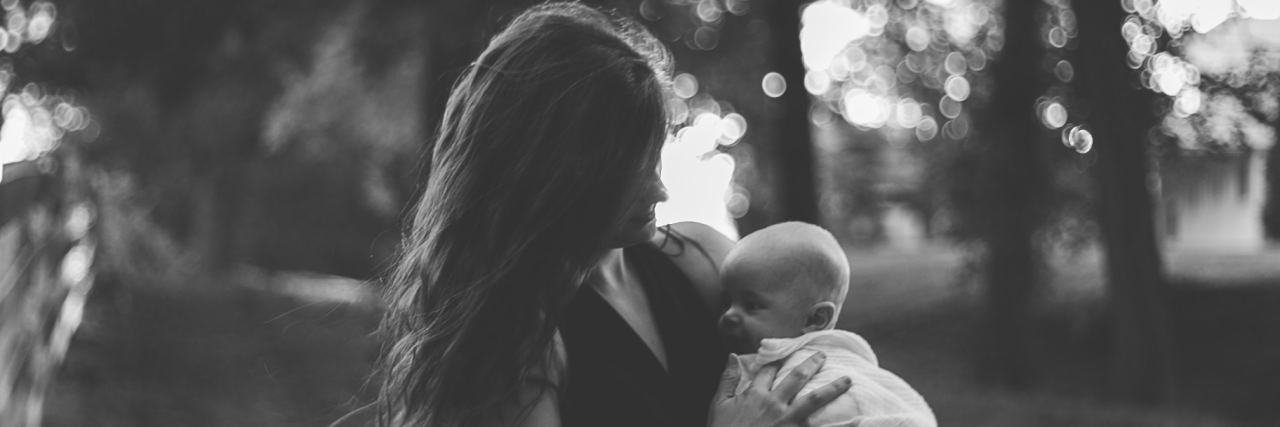 5 Things I Want Every Mom With Postpartum Depression to Know black and white photo of woman holding her baby outside