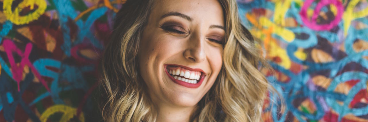 What It's Like to Be Happy and Depressed at the Same Time woman smiling