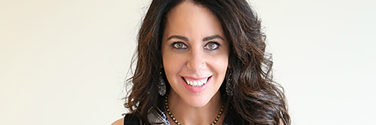 Fashion and Invisible Physical Disabilities Lainie holding her AFOs.