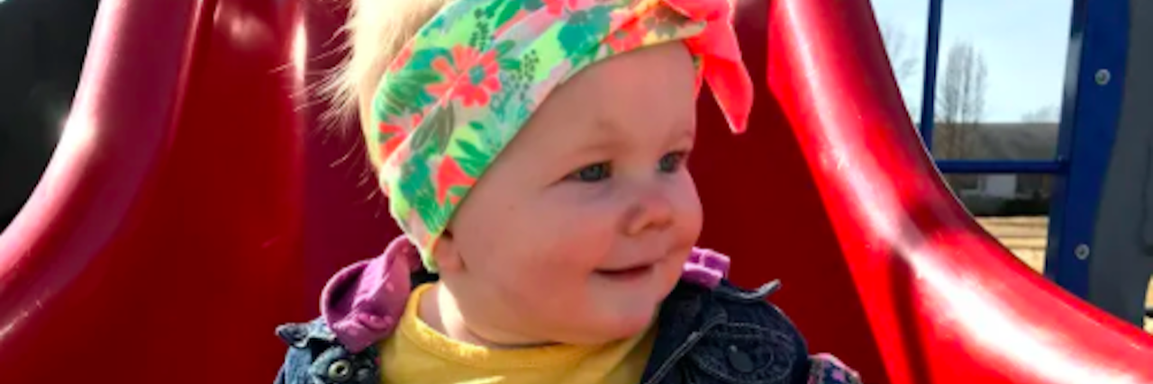 My Daughter's Limb Differences Are Nothing to Feel Sorry About Adorable little girl going down a slide, her right hand is missing