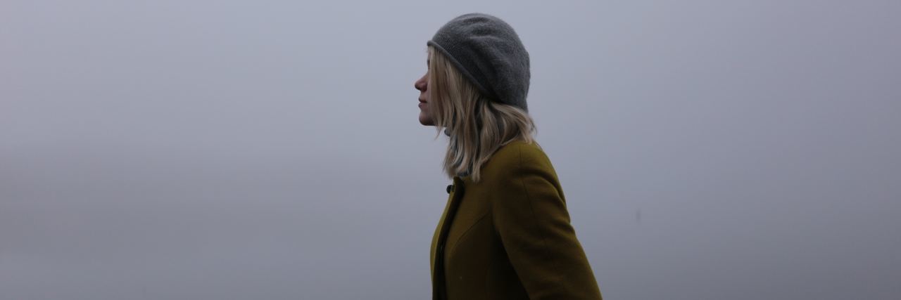 blond woman staring into the fog