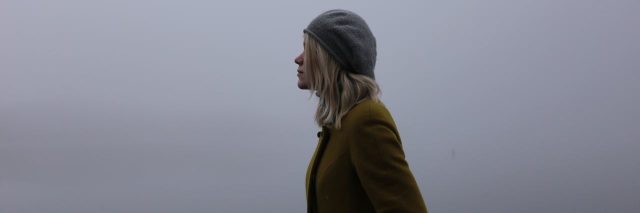 blond woman staring into the fog