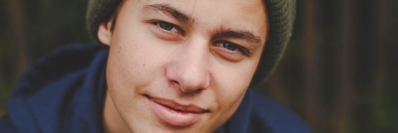 What I Want You to Know About My Son's Compulsive Hair-Pulling young man wearing hat looking into camera