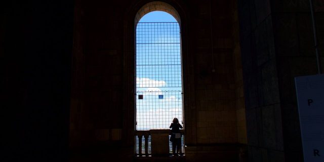 What It Was Like to Search for Treatment for My Rare Cancer The author standing in the shade, and the shadow of a window being cast