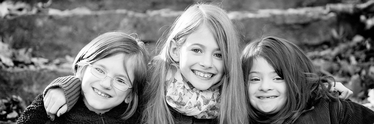 Things I’ve Learned From Having Two Siblings With Disabilities Black and white image of three sisters