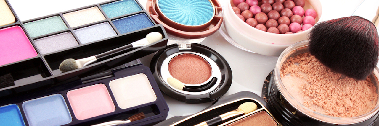 How Makeup Can Be Helpful When You Have Chronic Illness closeup photo of colorful eyeshadow, blush and other makeup products