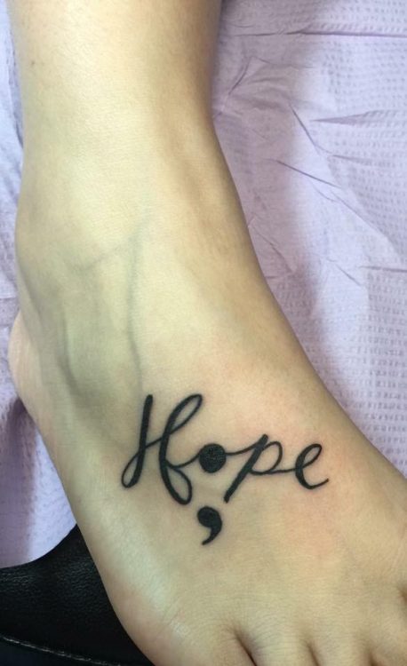 A tattoo on a foot that reads hope