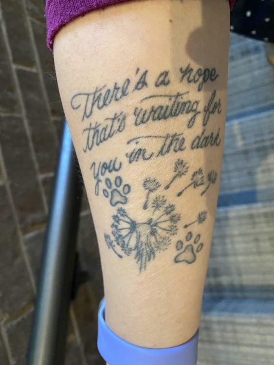 Tattoo with the words "there's a hope that's waiting for you in the dark"