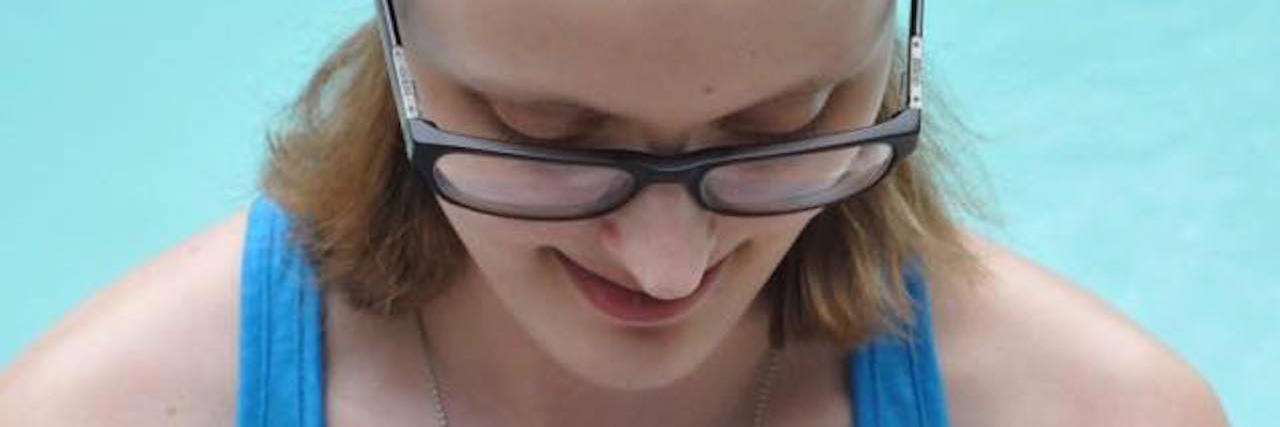 Why My Body Hates the Warmer Months A photo of the writer holding a flower.