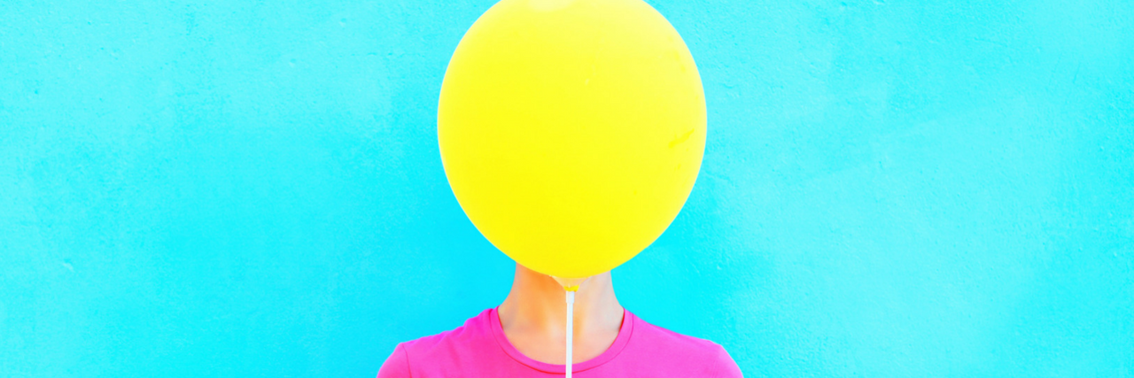 woman with balloon in front of her face