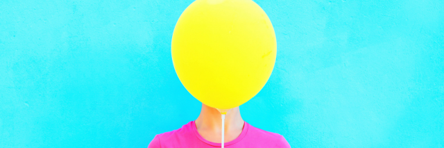 woman with balloon in front of her face