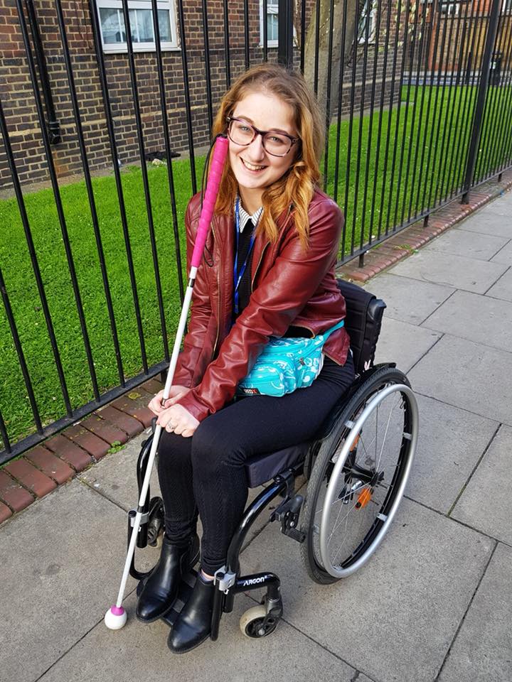 woman sitting in her wheelchair and smiling