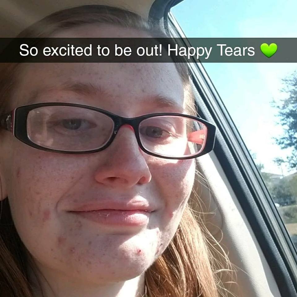woman taking a selfie in the car with the caption "so excited to be out!! happy tears"