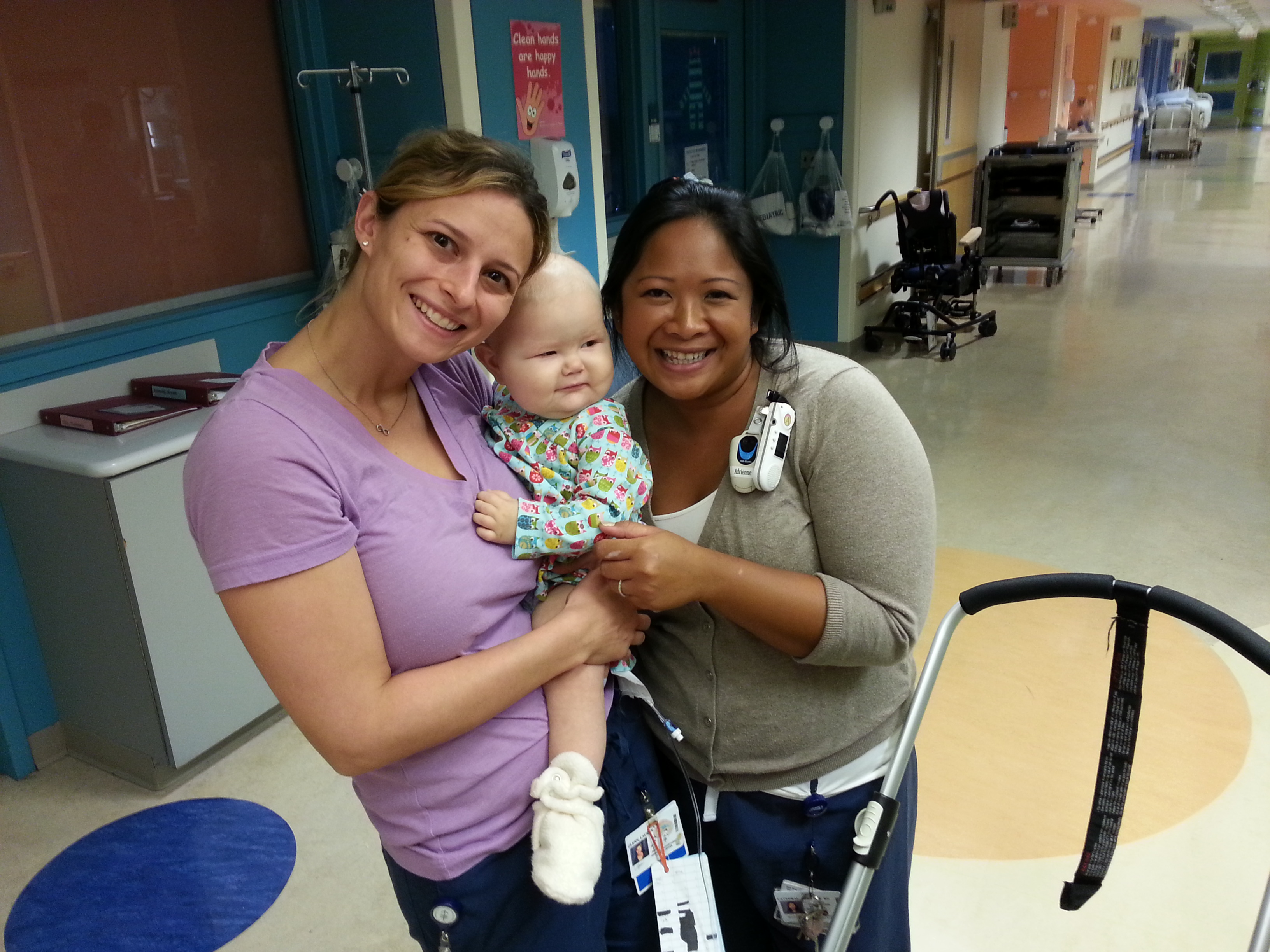 nurses holding little girl