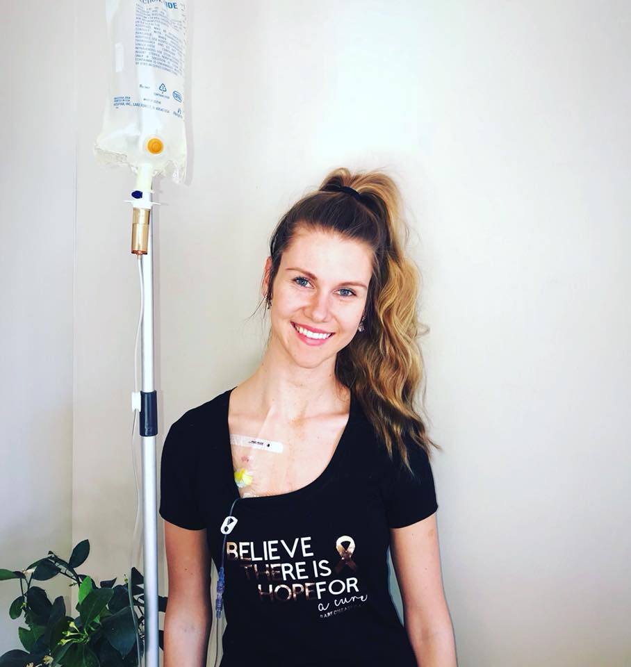 woman standing next to an IV pole