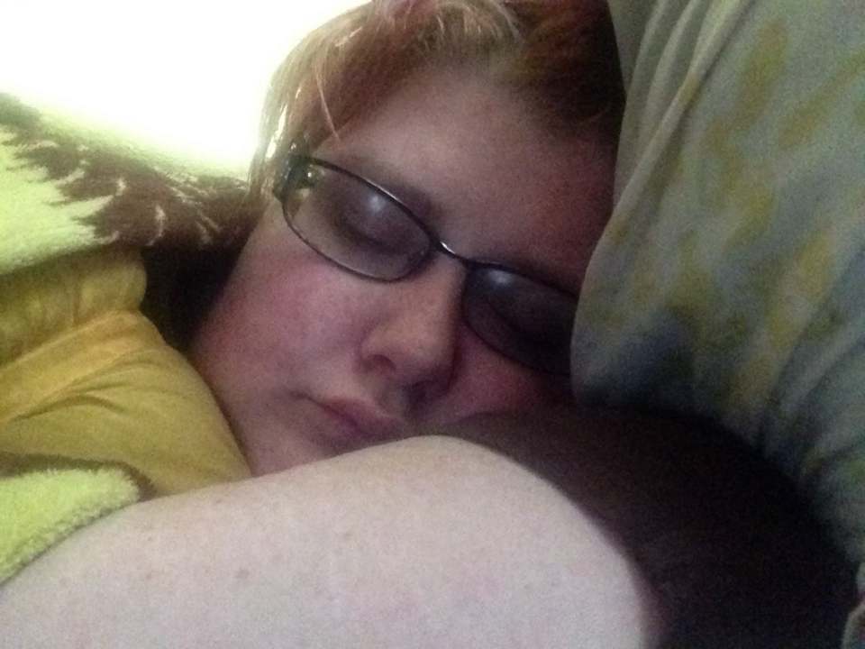 woman wearing glasses and lying on the couch sleeping