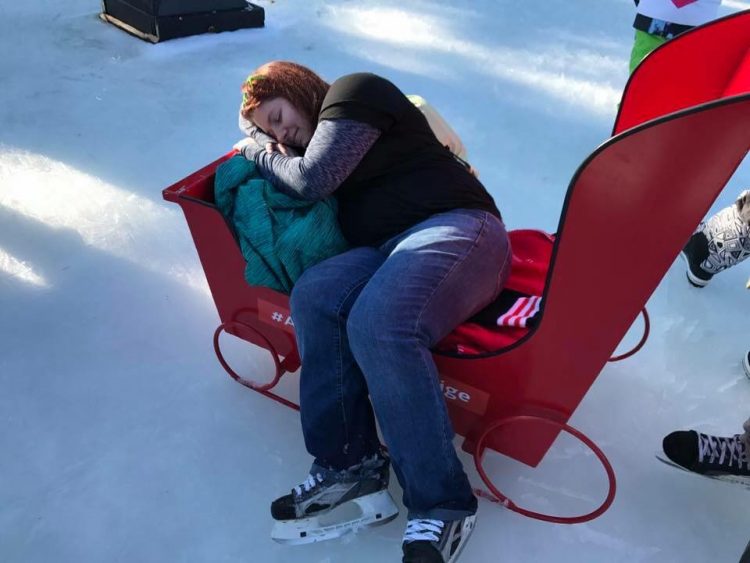 woman slumped over on sled resting