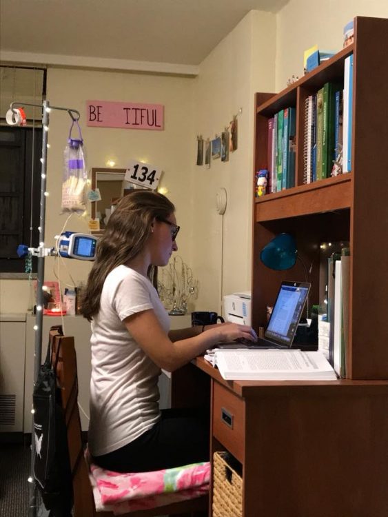 young woman sitting at desk using computer