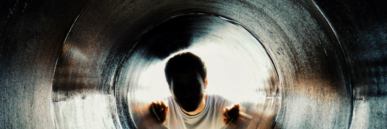 The 22 Parts of Anxiety That Were Hardest for People to Accept person looking through dark hole