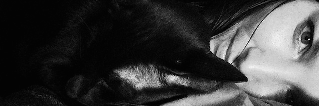 What It's Like Being Secretly Poor and Disabled in America shana mattick black and white photo in bed with cat