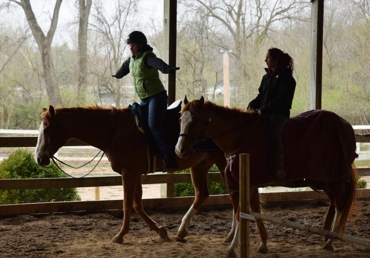 Sally and a friend each riding a horse