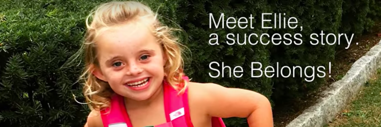 Youtube video screen shior of Ellie, who has Down syndrome, and the caption "Meet Ellie, a success story. She belongs."