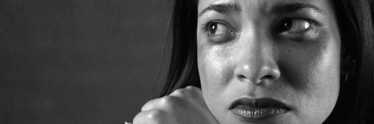 Experiencing Anxiety as a Racial Minority in America A young woman sits weeping.