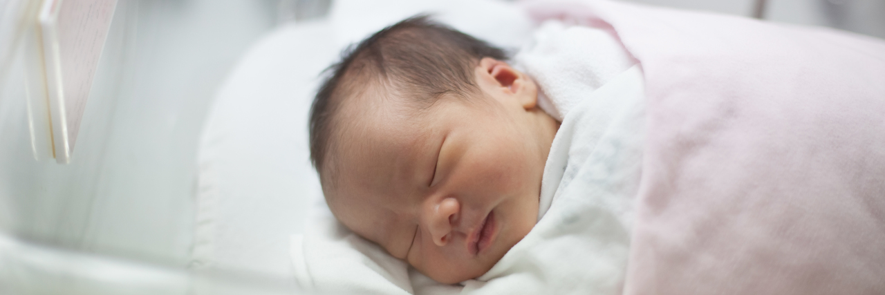 The Parenting Lie I Was Told That I Will Never Tell New Parents face of first day new born in hospital delivery room