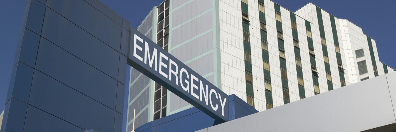 Emergency Sign on Hospital entrance against blue sky