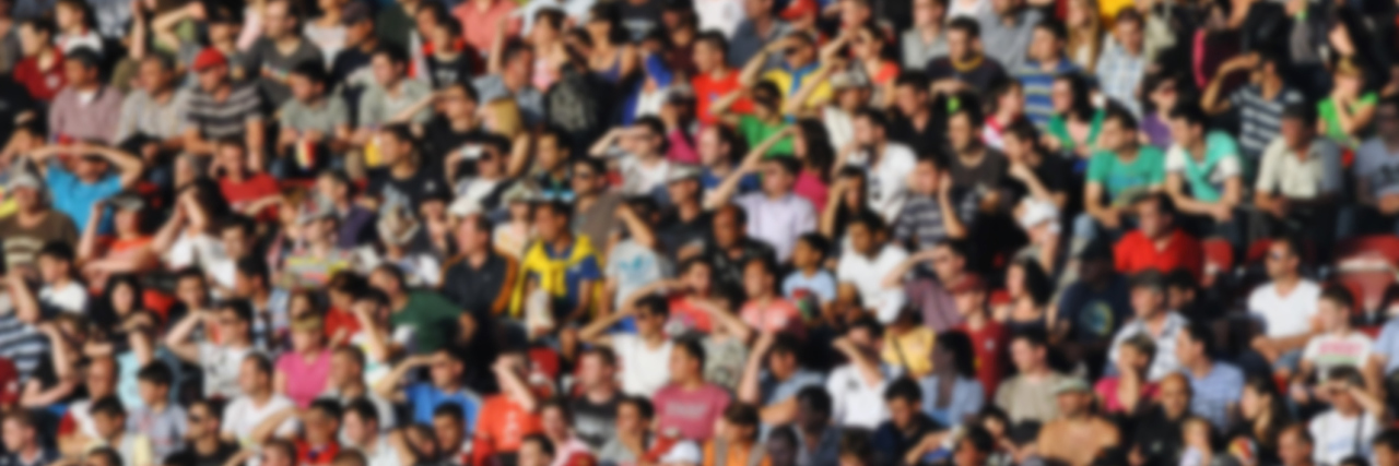 A blurred crowd of people in a stadium.