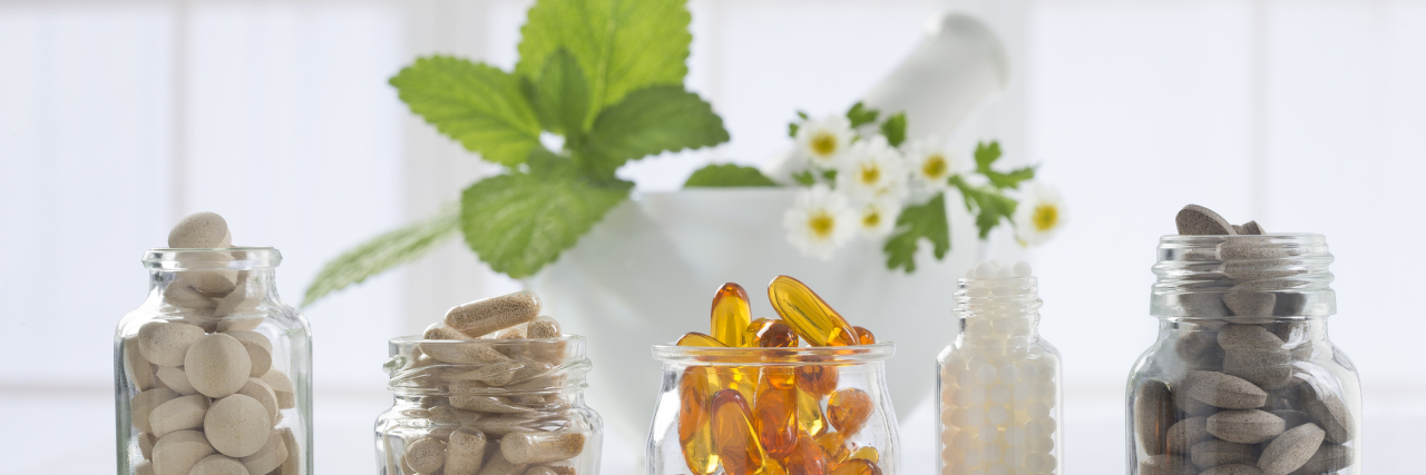 When People Sell You Fake Health 'Cures' for Your Chronic Illness several bottles of supplements sitting on a counter