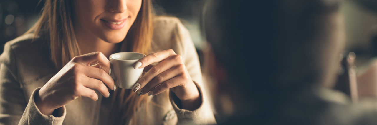 When Social Anxiety Thoughts Interrupt a Coffee Date young man and woman drinking coffee on date with camera positioned over man's shoulder