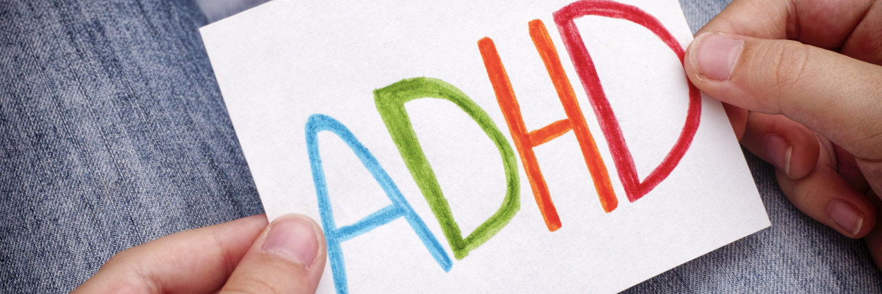 Accepting ADHD as a Disability ADHD text written on sheet of paper.