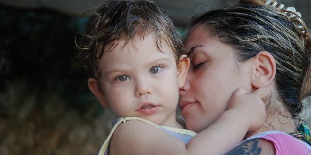 When the Energy of a Toddler and Rheumatoid Arthritis Don't Match A mother holding her young son.