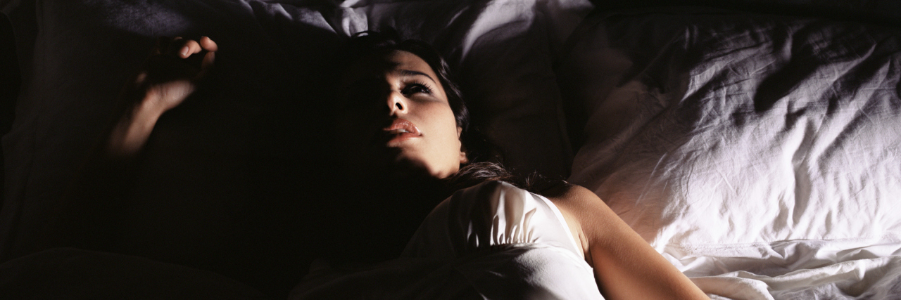 Tips for Coping With Insomnia woman lying in bed awake at night